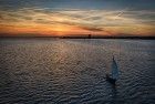 Sailing boat during sunset on lake Gooimeer