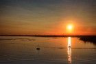 Sailing boats on lake Gooimeer during sunset