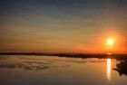 Sailing boats on lake Gooimeer during sunset