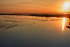 Sailing boat on lake Gooimeer during sunset