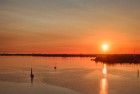 Sailing boats on lake Gooimeer during sunset