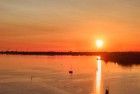 Sailing boats on lake Gooimeer during sunset