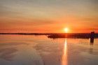 Sailing boats on lake Gooimeer during sunset