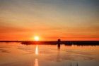 Sailing boats on lake Gooimeer during sunset