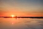 Sailing boats on lake Gooimeer during sunset