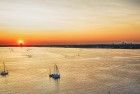 Boats on lake Gooimeer during sunset