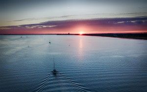 Sailing home on lake Gooimeer during sunset