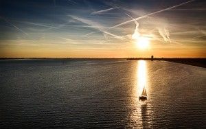 Sailing boat during sunset on lake Gooimeer