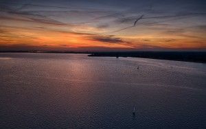 Lonely sailing boats on lake Gooimeer during sunset