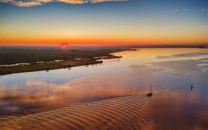 Sunset drone picture of lake Eemmeer, as a boat passes