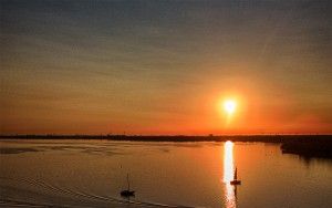 Boats on lake Gooimeer during sunset