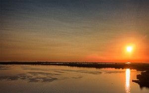 Sailing boats on lake Gooimeer during sunset