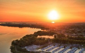 Sailing boats on lake Gooimeer during sunset