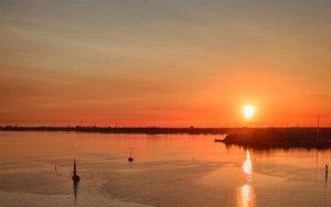 Sailing boats on lake Gooimeer during sunset