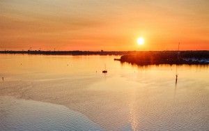 Sailing boats on lake Gooimeer during sunset