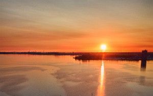 Sailing boats on lake Gooimeer during sunset