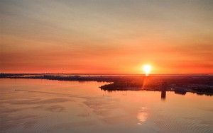 Sailing boats on lake Gooimeer during sunset