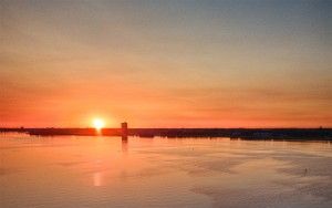 Sailing boats on lake Gooimeer during sunset