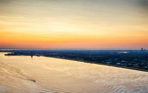 Boats sailing on lake Gooimeer during sunset