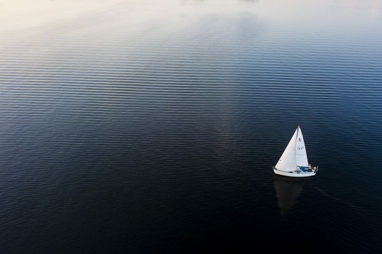 Sailing boat during sunset on lake Gooimeer