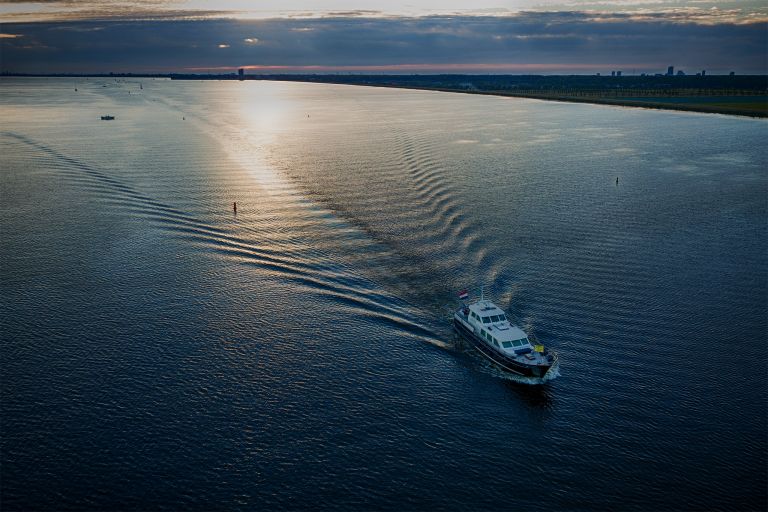 Motor boat cruising over lake Gooimeer