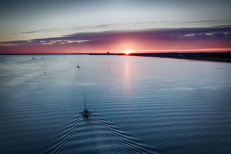 Sailing home on lake Gooimeer during sunset