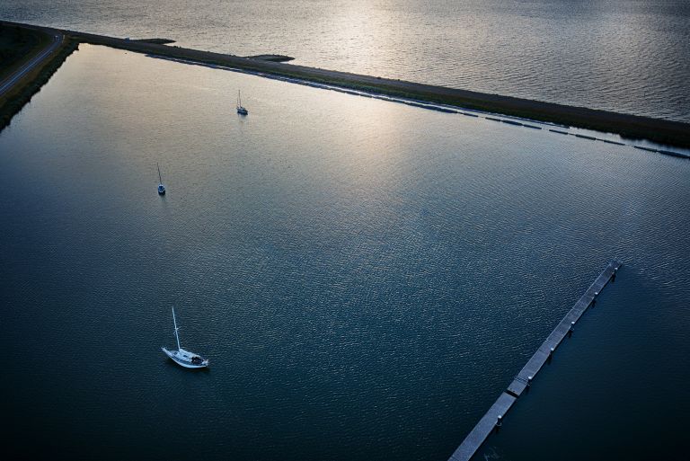 Boats at Oostvaardersdiep during sunset