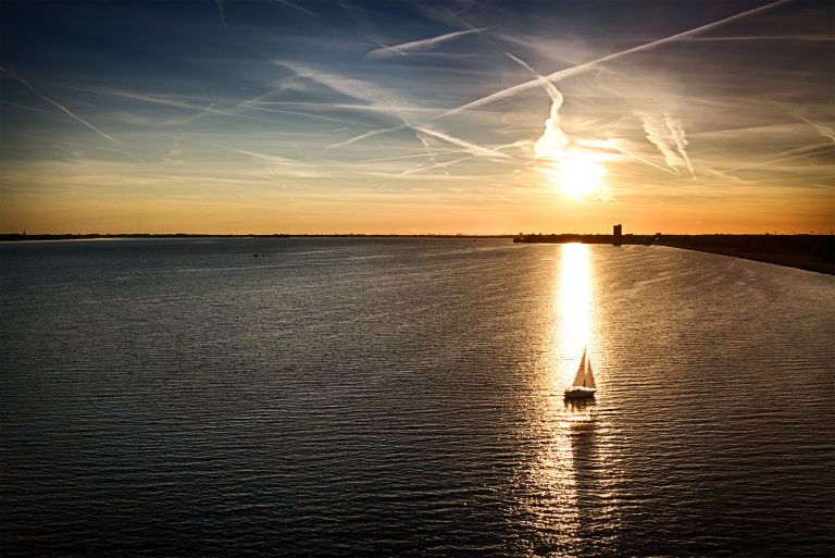 Sailing boat during sunset on lake Gooimeer