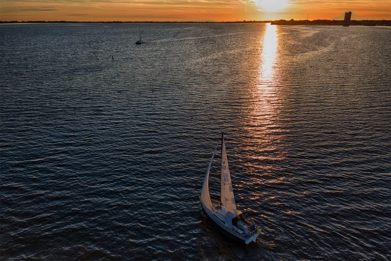 Sailing boat on lake Gooimeer during sunset