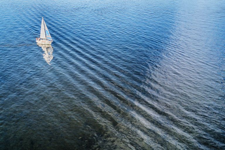 Sailing father on lake Gooimeer