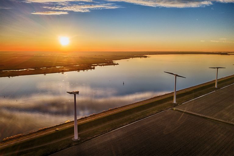 Sunset drone picture of windmills on Eemmeerdijk