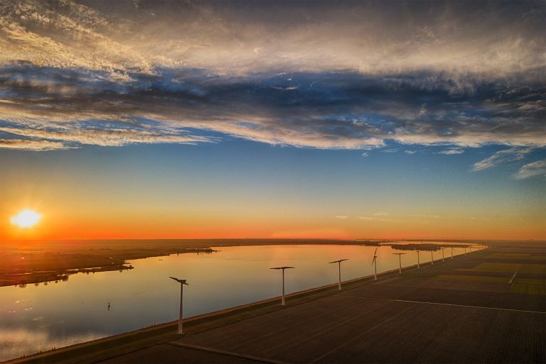 Fields, windmill and lake Eemmeer from my drone during sunset