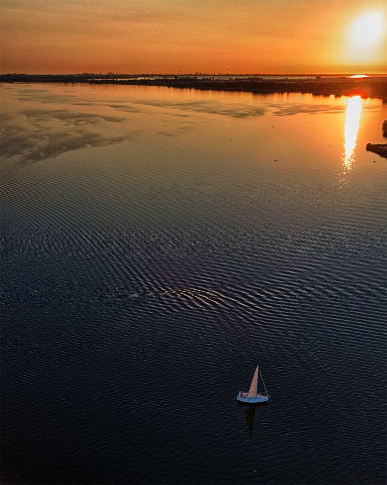 Sailing boat on lake Gooimeer during sunset