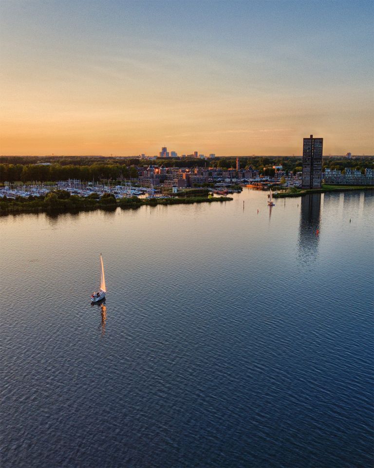 Sailing boat on lake Gooimeer during sunset