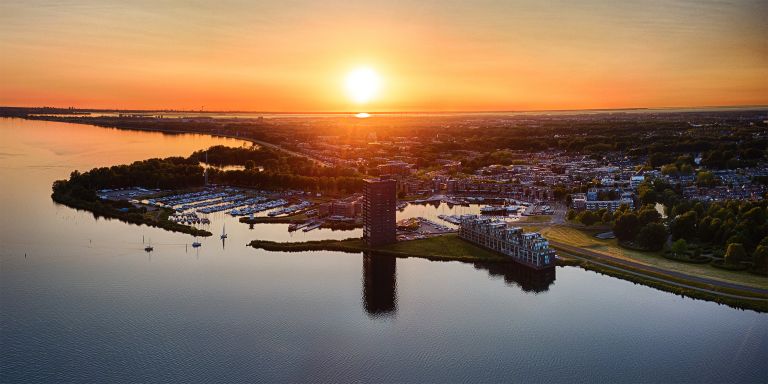 Drone panorama of sailing boats on lake Gooimeer during sunset