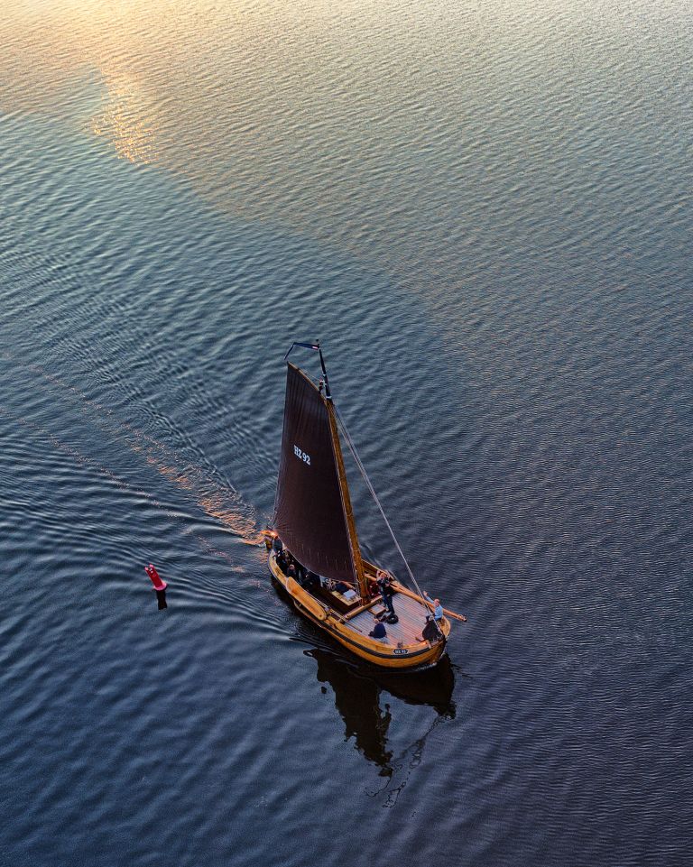 Sailing boat on lake Gooimeer during sunset