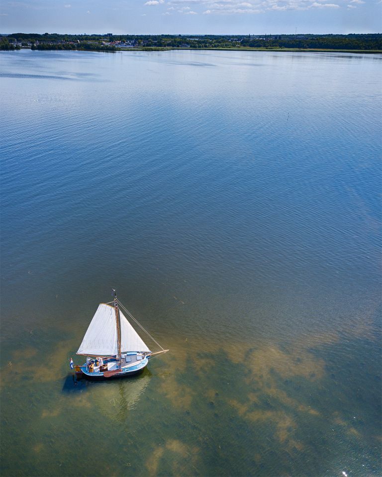 Drone picture of sailing boat on lake Gooimeer