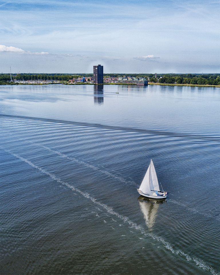 Drone picture of sailing boat on lake Gooimeer