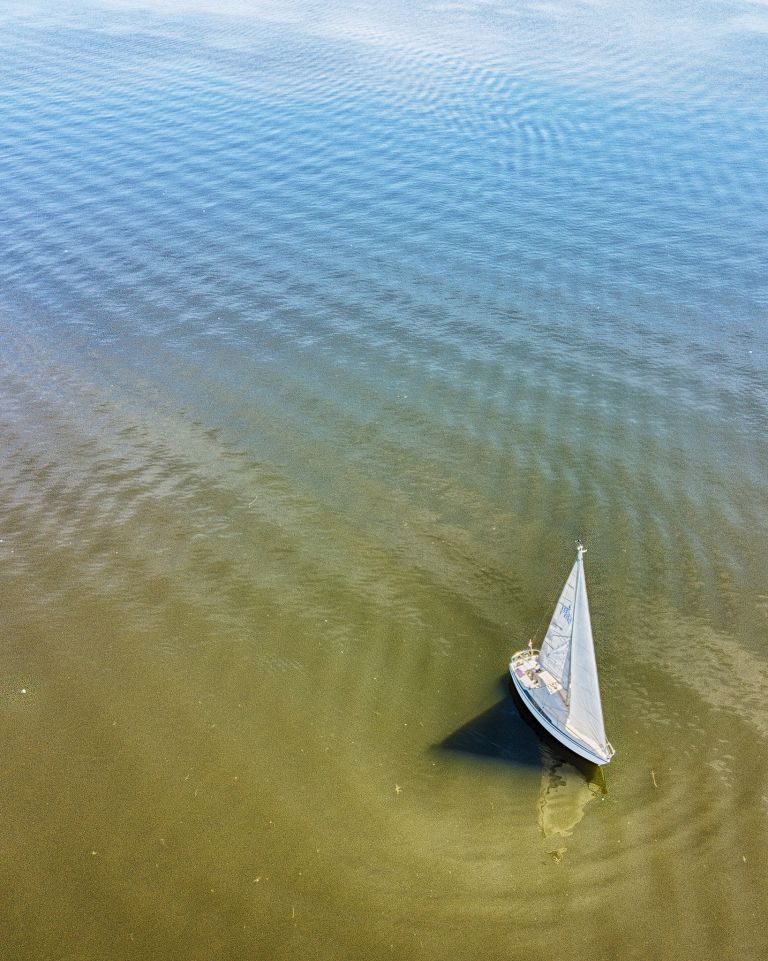 Drone picture of sailing boat on lake Gooimeer