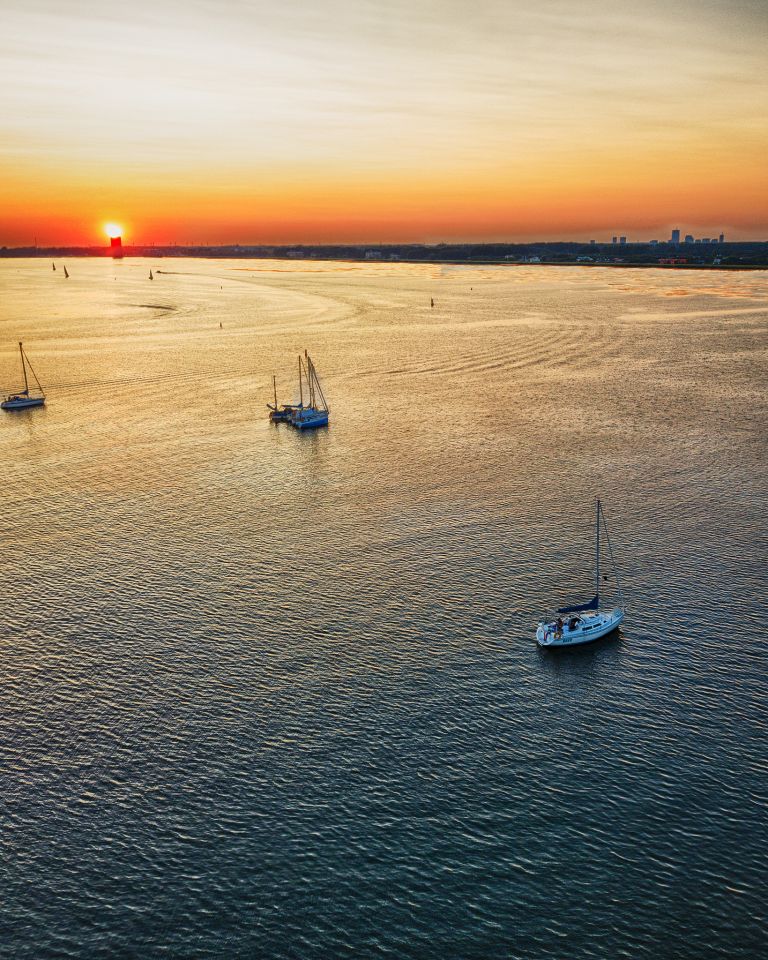 Boats on lake Gooimeer during sunset