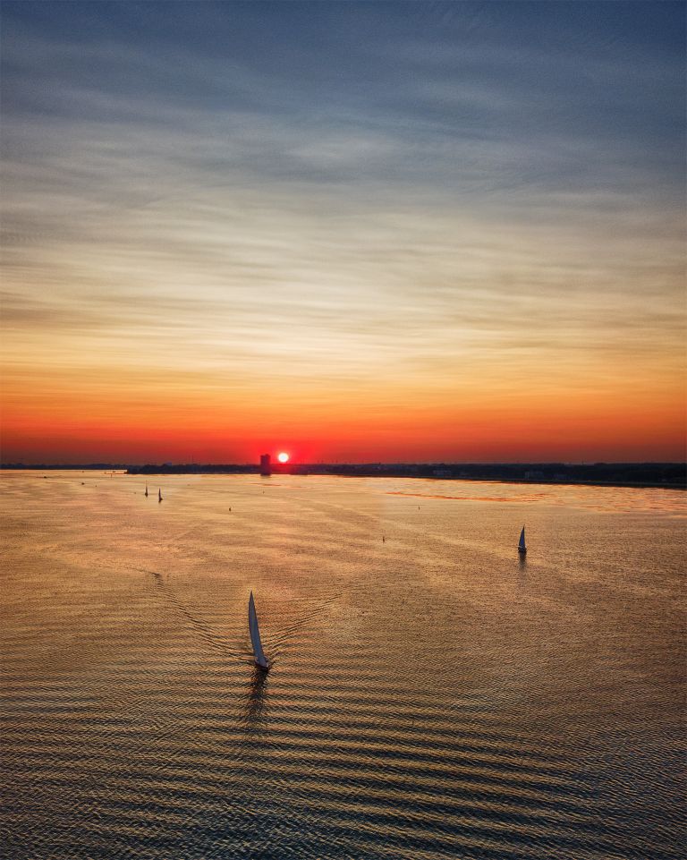 Sailing during sunset on lake Gooimeer