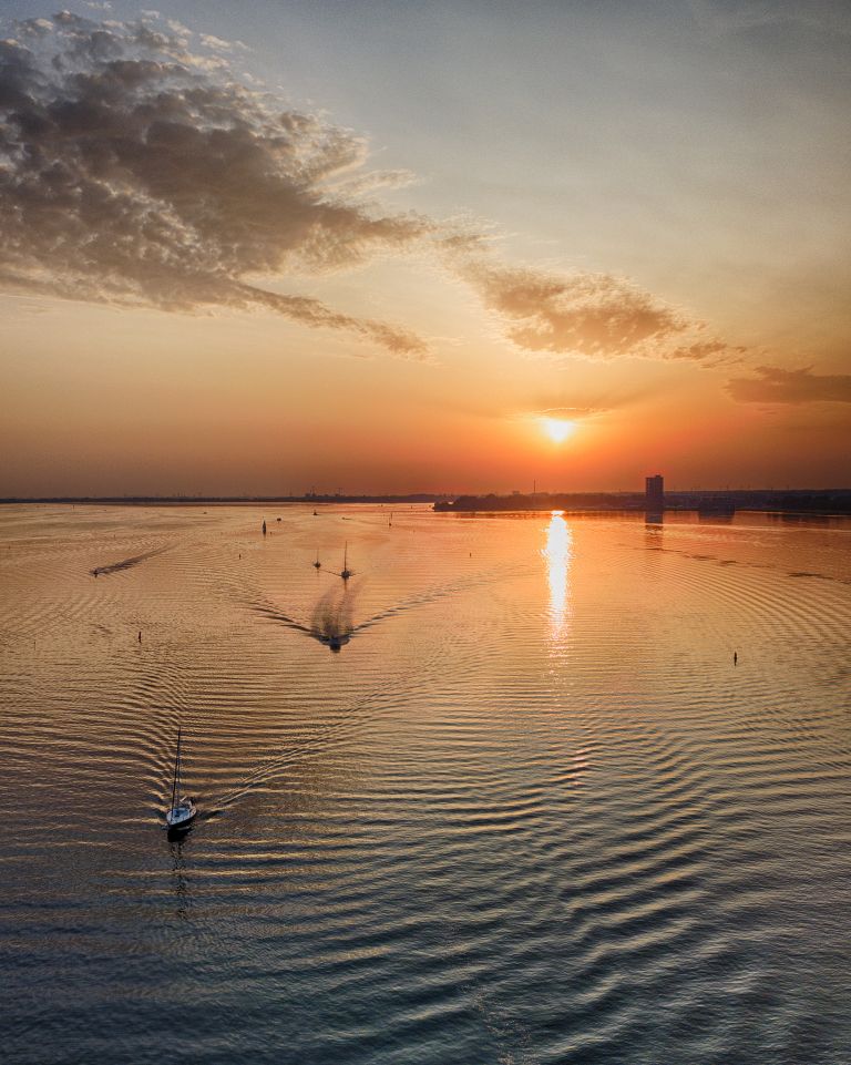 Boats on lake Gooimeer during sunset